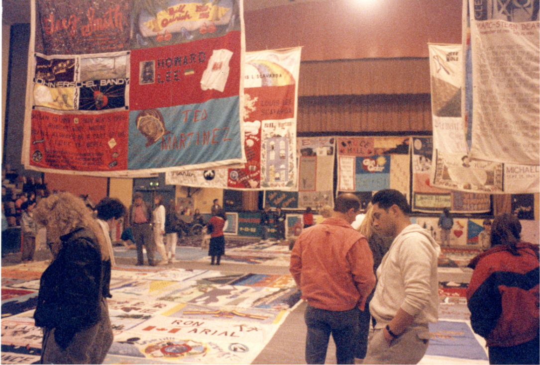 AIDS quilt display covering floor and hanging from ceiling.
