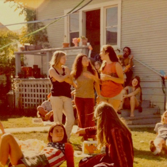 Gathering of people in a house yard.